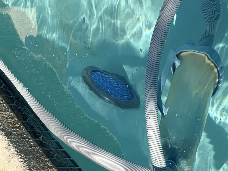 Pool vacuum and cleaning hose working underwater during service