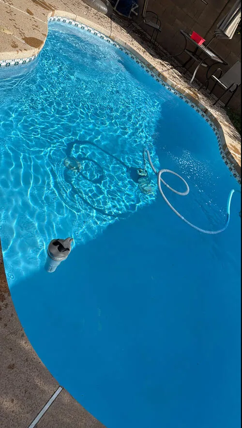 Pool with cleaning equipment during weekly maintenance